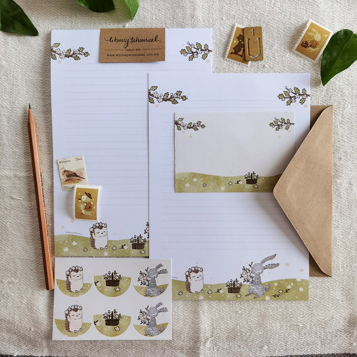 Summer Meadow Blooms Letter Writing Set - Immerse in a whimsical world as a rabbit and hedgehog create flower crowns on these delightful letter writing sheets, capturing the essence of summer.