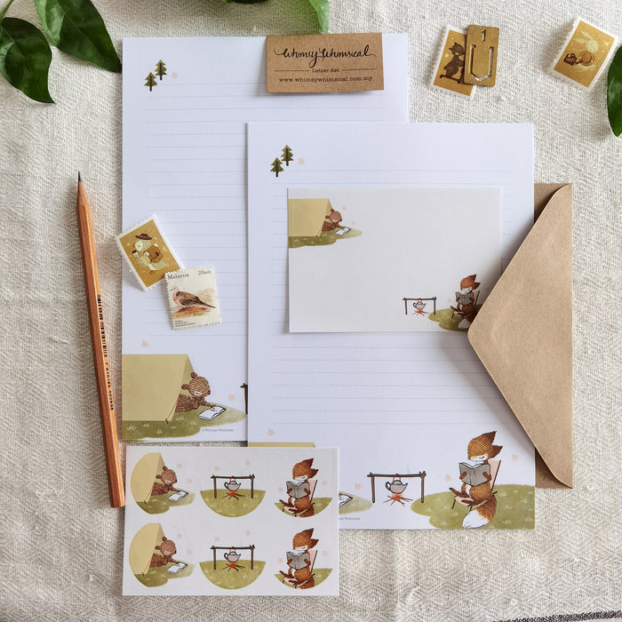Summer Letter Writing Set - Summer Campfire, showcasing the great outdoors and depict a charming scene with a little fox and squirrel engrossed in reading during a summer camping escapade.