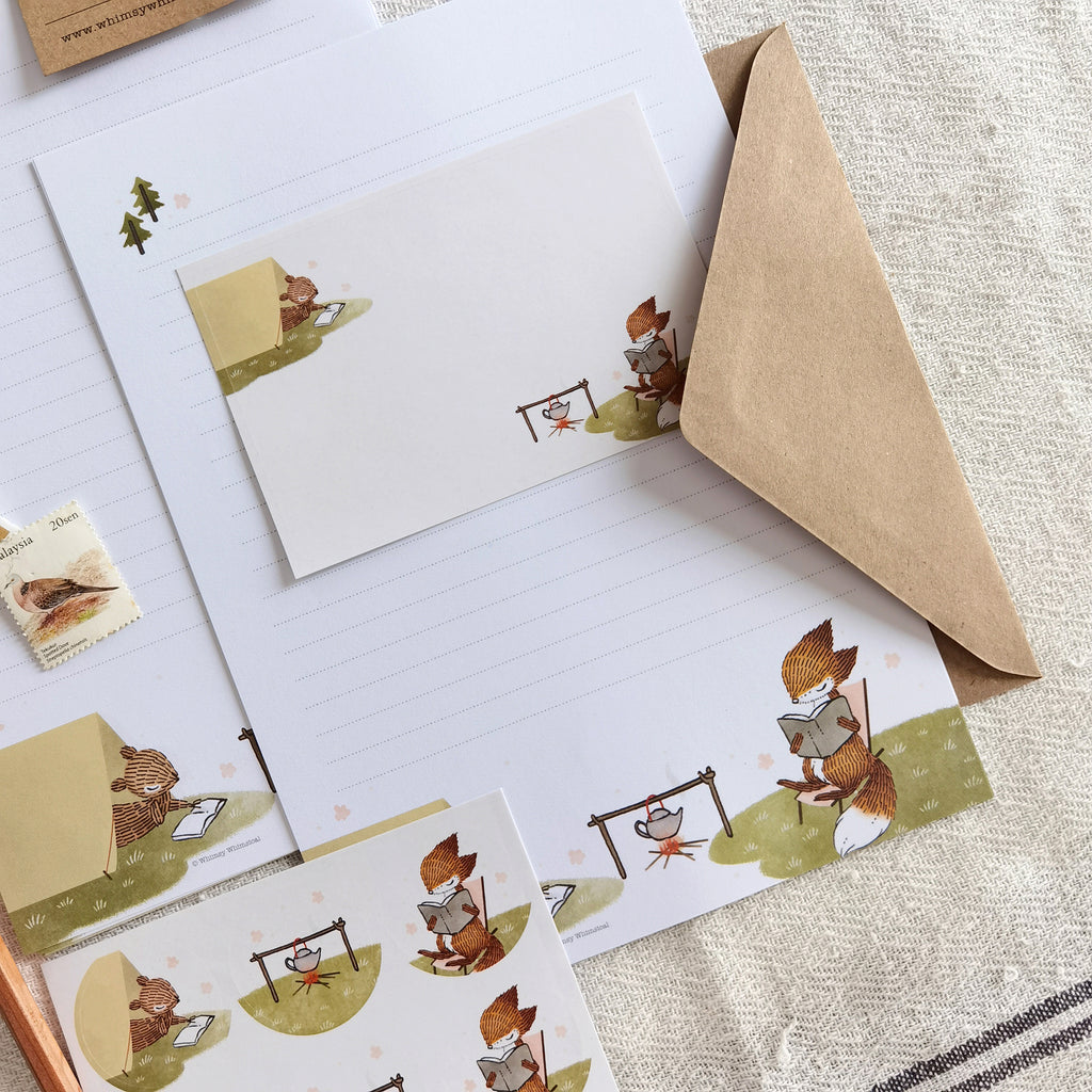 Summer Campfire Letter Writing Set - Charming scene of a little fox and squirrel immersed in reading during a summer camping adventure, capturing the spirit of the great outdoors.