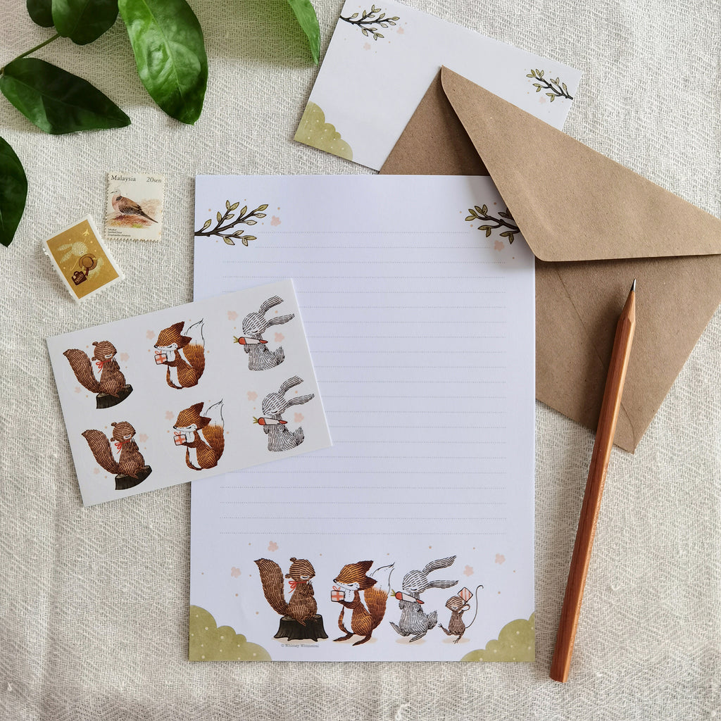 Summer Celebration Delights Letter Writing Set - Heartwarming scenes of woodland animals exchanging gifts, capturing the joy of summer with playful squirrels and cute rabbits.