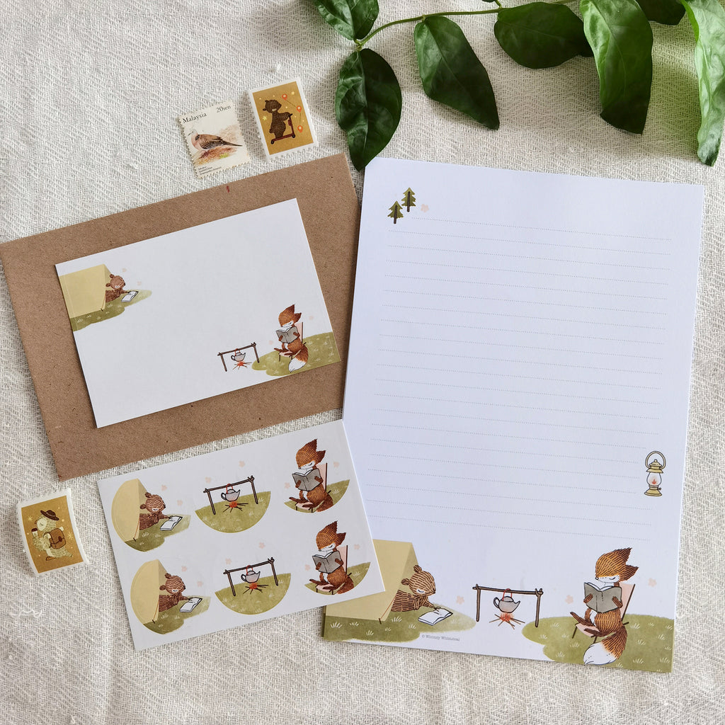 Summer Campfire Letter Writing Set - Charming scene of a little fox and squirrel immersed in reading during a summer camping adventure, capturing the spirit of the great outdoors.