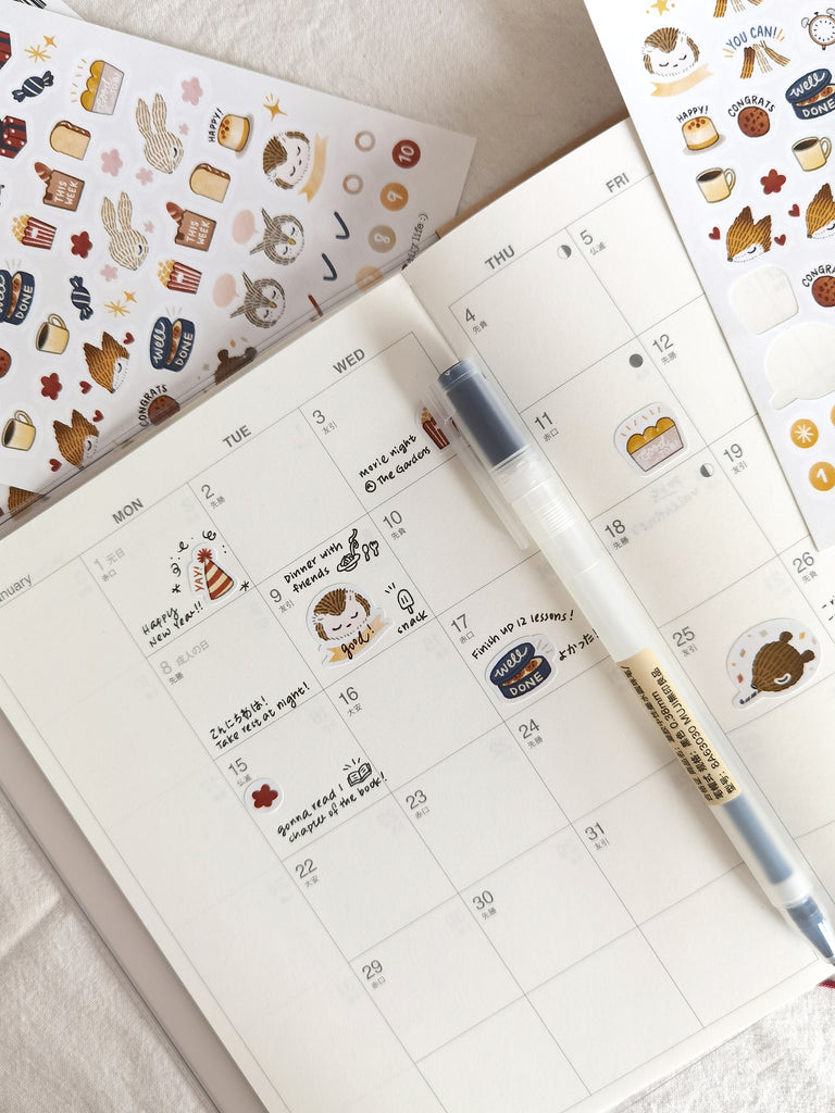 Planner sticker sheet with encouraging woodland animals, scrumptious cookies, presents, and party hat illustrations to decorate your planner.