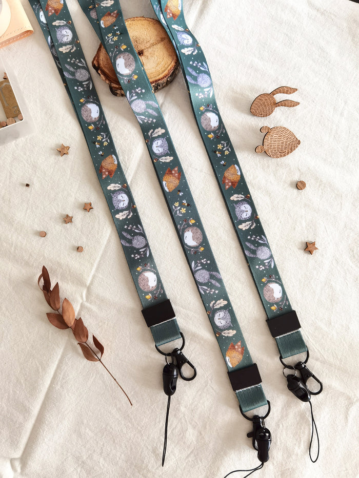 Long lanyard adorned with forest critters, flowers, and bees illustrations. A charming accessory for daily whimsy, keys & ID badge holder.