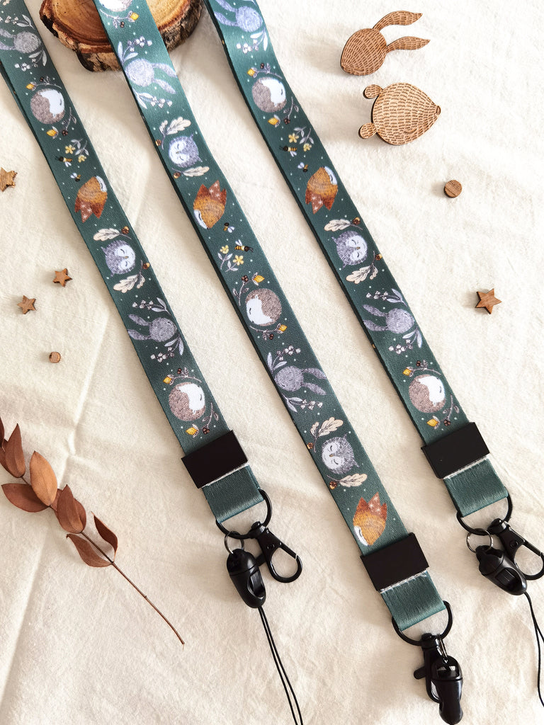 Long lanyard adorned with forest critters, flowers, and bees illustrations. A charming accessory for daily whimsy, keys & ID badge holder.