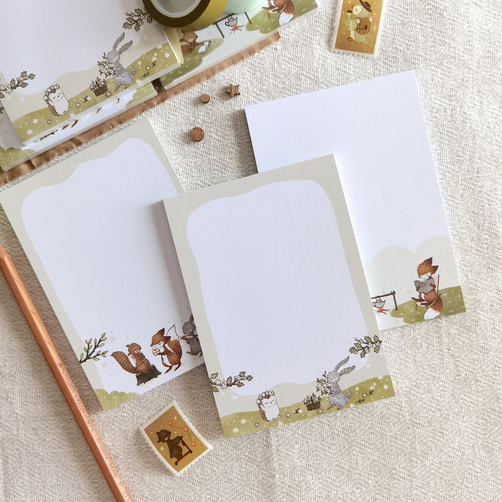 Summer Meadow Blooms Memo Pad - Whimsical rabbit and hedgehog crafting flower crowns under the summer sun, capturing the essence of the outdoor season.
