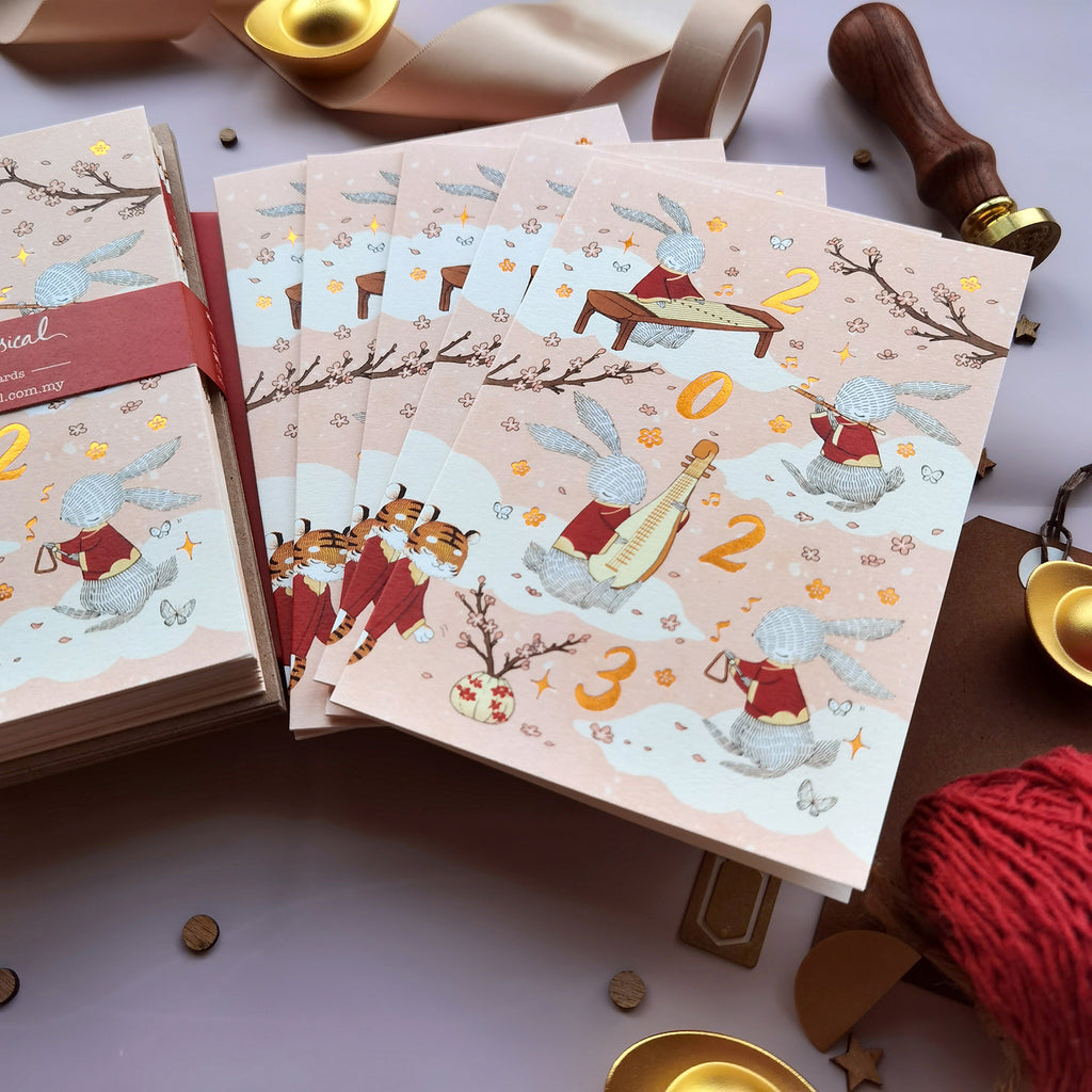 Rabbit Year 2023 CNY Card with illustrated rabbits performing Chinese Orchestra music, printed with copper foil stamping. Perfect for festive greetings.