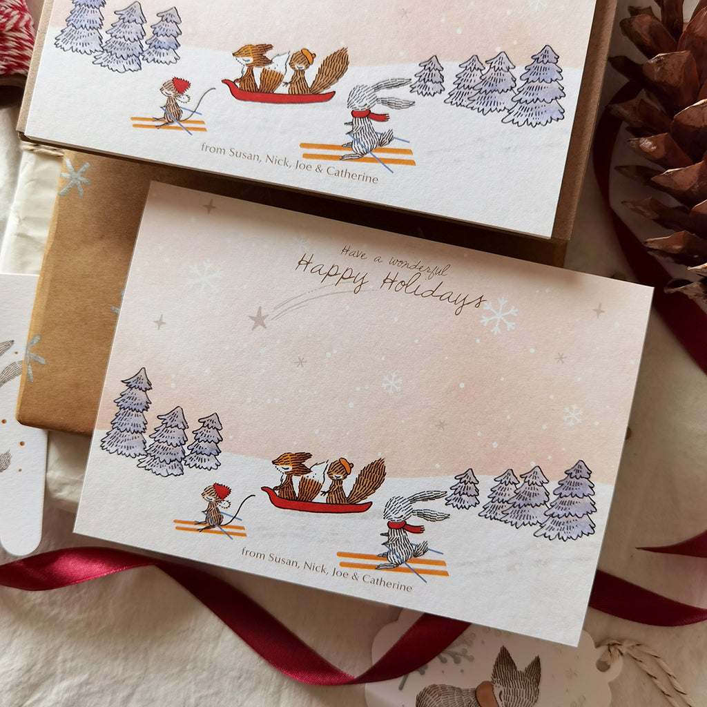 Illustrated snow skiing animals on flat notecards perfect for joyful holiday greetings, personalized names at the bottom.